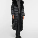 Black quilted down coat with faux fur hood collar worn with gray turtleneck sweater and black trousers — Max Mara | Endless UAE