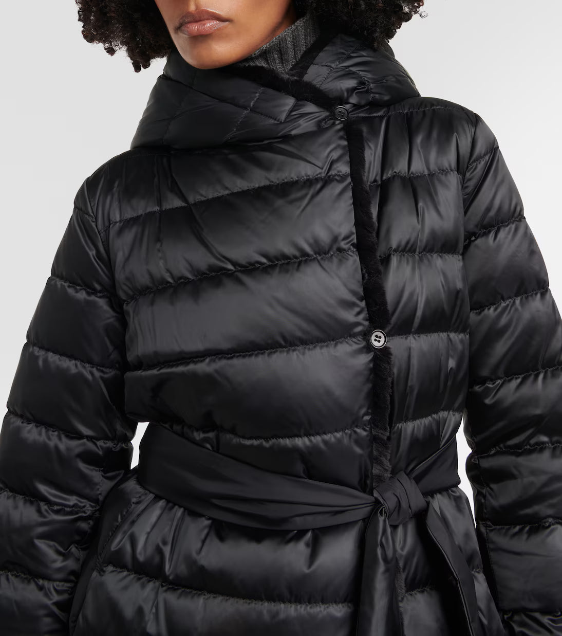 Black quilted down coat with tie waist belt and high collar on model — Max Mara | Endless UAE