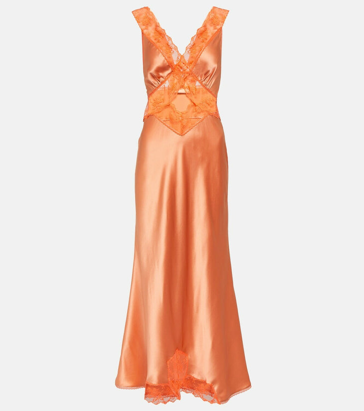 Woman wearing Aries Cut Out Gown in orange peach with lace details and gold sandals — Sir The Label | Endless UAE