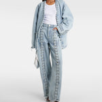 Light blue straight-leg denim jeans with decorative lace-up detailing down the front legs and frayed hem — Rotate | Endless UAE