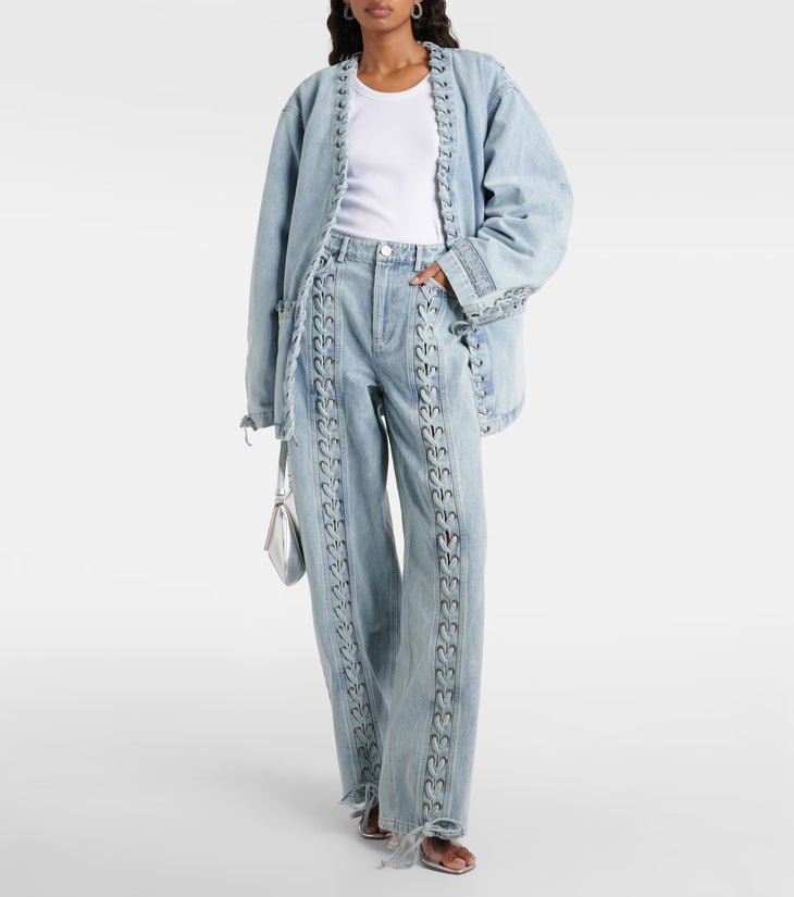 Light blue straight-leg denim jeans with decorative lace-up detailing down the front legs and frayed hem — Rotate | Endless UAE