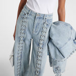 Light blue straight-leg jeans with decorative lace-up detailing along the front seams, paired with matching denim jacket — Rotate | Endless UAE