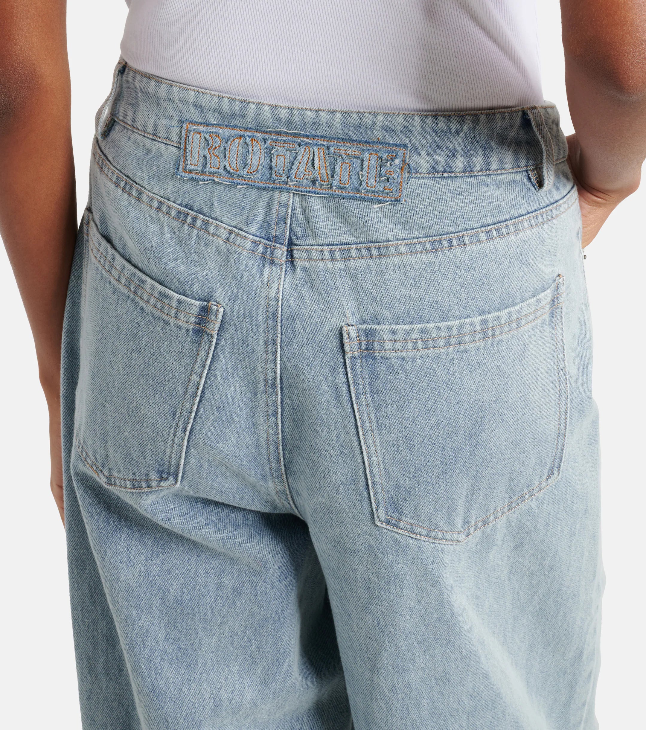 Light blue straight-leg jeans with embroidered logo detail at back waistband and classic five-pocket styling — Rotate | Endless UAE