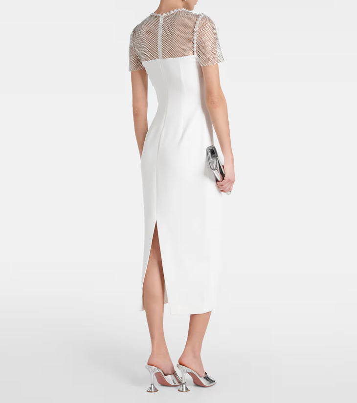 Elegant white midi dress with sheer embellished mesh sleeves and back slit, model holding silver clutch — Self-portrait | Endless UAE