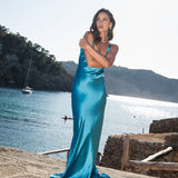 Woman wearing teal sleeveless maxi dress by water — By Keara | Endless UAE