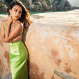 Lime green Scoop Dress with open back detail worn by model against textured wall — By Keara | Endless UAE