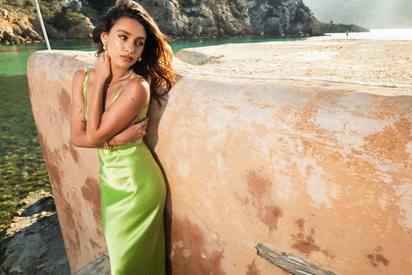 Lime green Scoop Dress with open back detail worn by model against textured wall — By Keara | Endless UAE