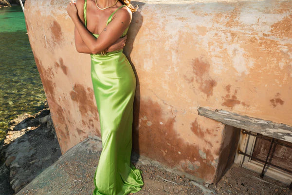 Lime green Scoop Dress with open back detail worn by model against textured wall — By Keara | Endless UAE
