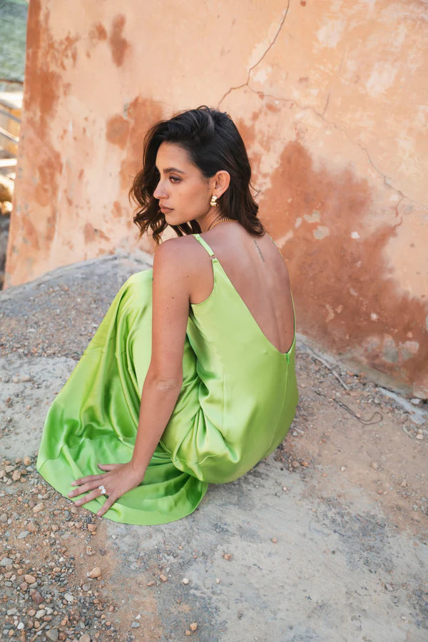 Lime green Scoop Dress with open back detail worn by model against textured wall — By Keara | Endless UAE