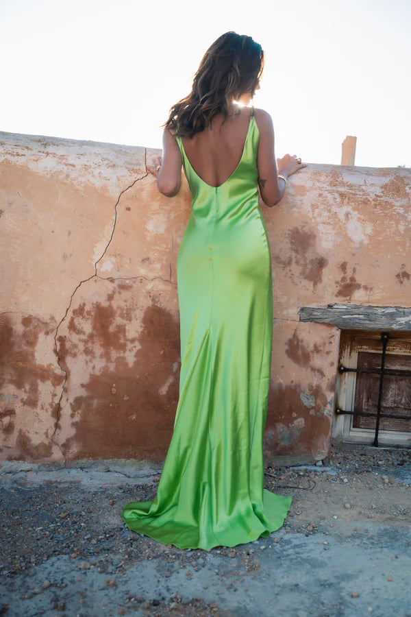 Lime green Scoop Dress with open back detail worn by model against textured wall — By Keara | Endless UAE