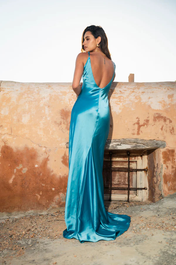 Woman wearing teal sleeveless maxi dress by water — By Keara | Endless UAE