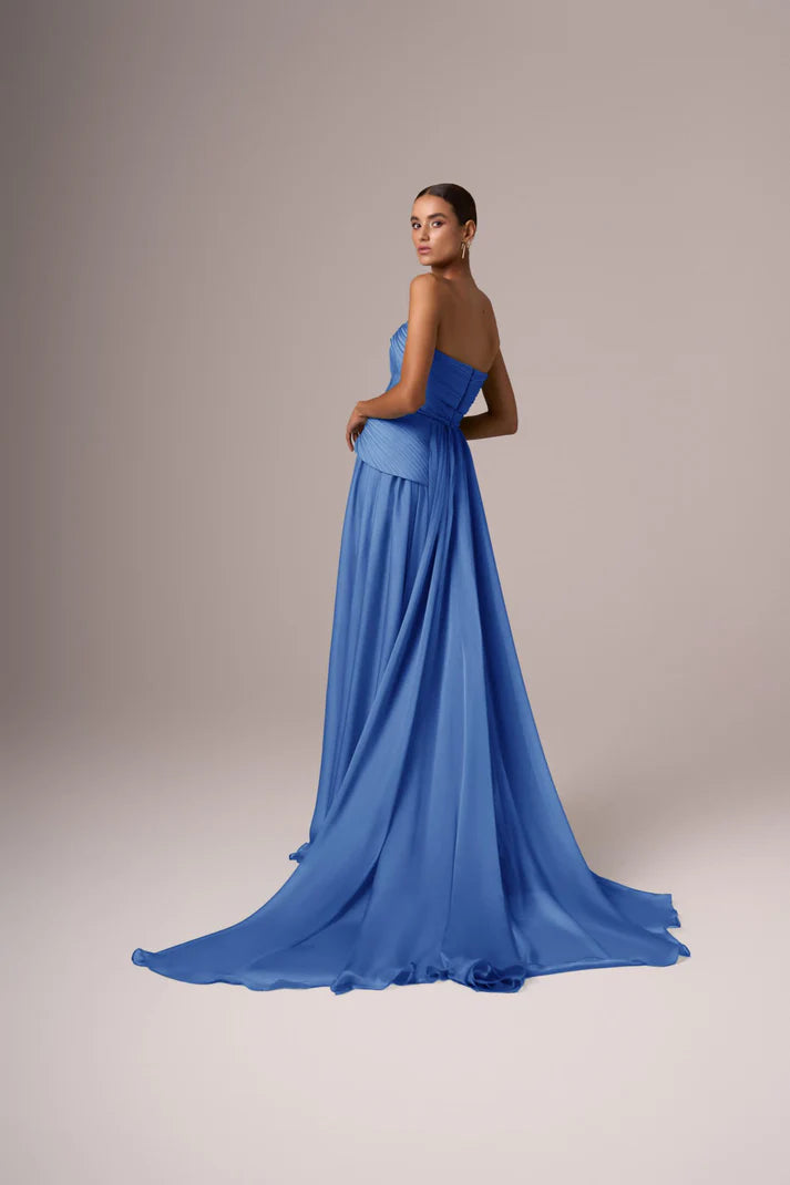 Elegant blue strapless chiffon gown with pleated bodice and flowing train, worn by model in studio setting — Eli The Label | Endless UAE
