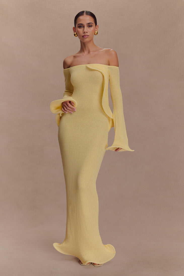 Woman wearing yellow off-shoulder ribbed knit maxi dress with ruffled details — Meshki | Endless UAE