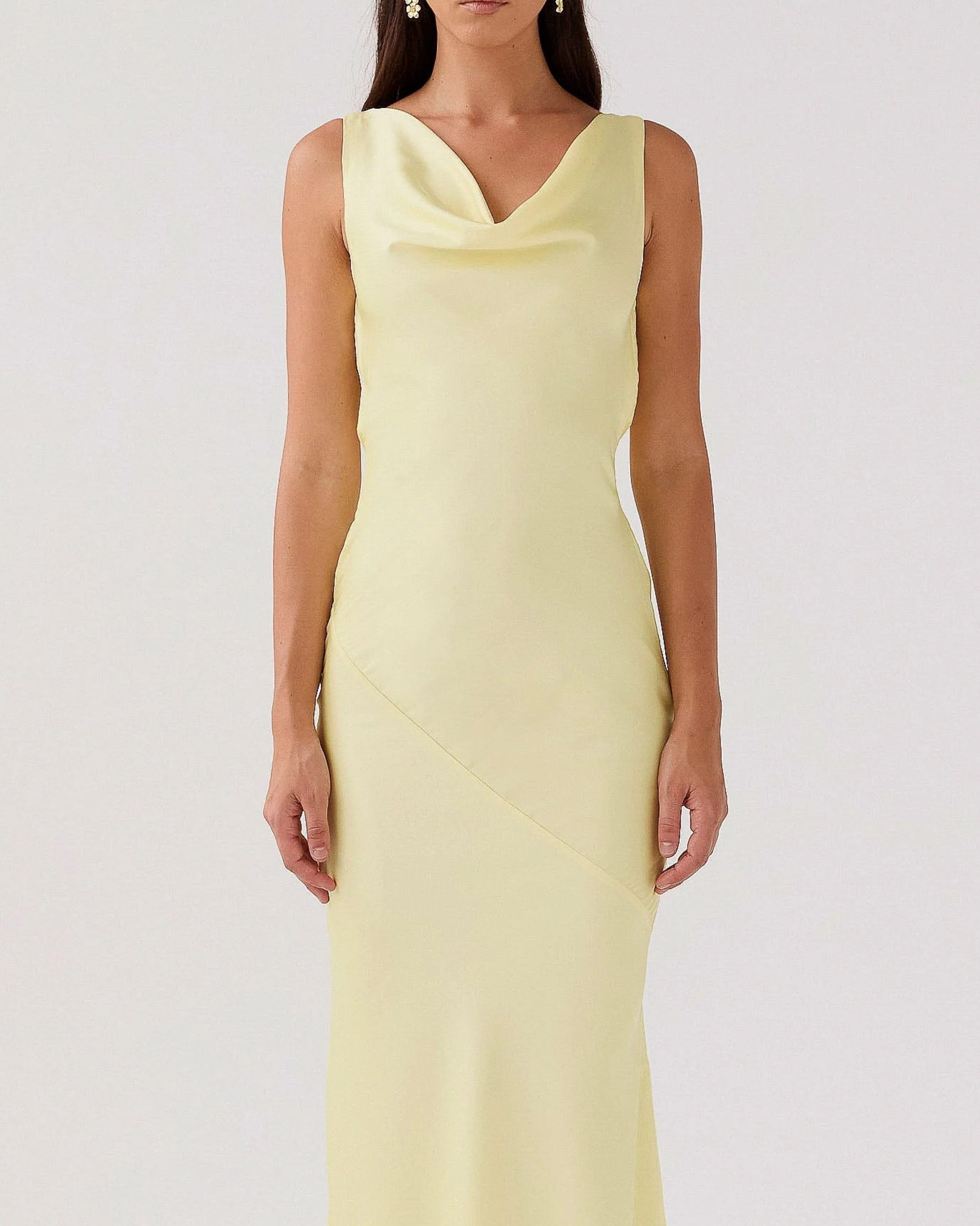 Woman wearing pale yellow satin sleeveless maxi dress with cowl neckline — Peppermayo | Endless UAE