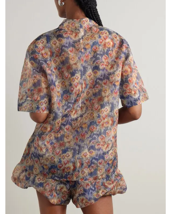 Woman wearing floral-print silk-organza shirt and shorts with brown woven bag — Sir The Label | Endless UAE