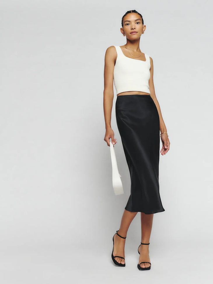Black silk midi skirt with white crop tank top and black platform sandals — Reformation | Endless UAE