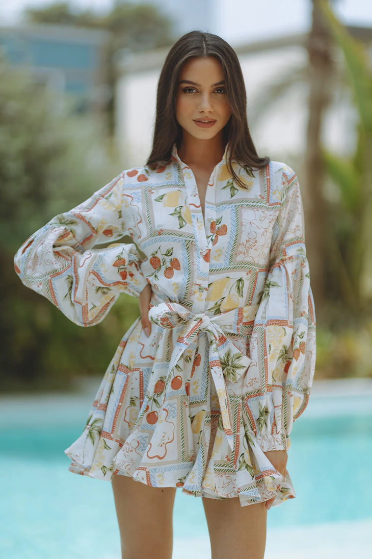 Woman wearing Tessa Linen Mini Dress with fruit print and puffed sleeves — Chic Le Frique | Endless UAE