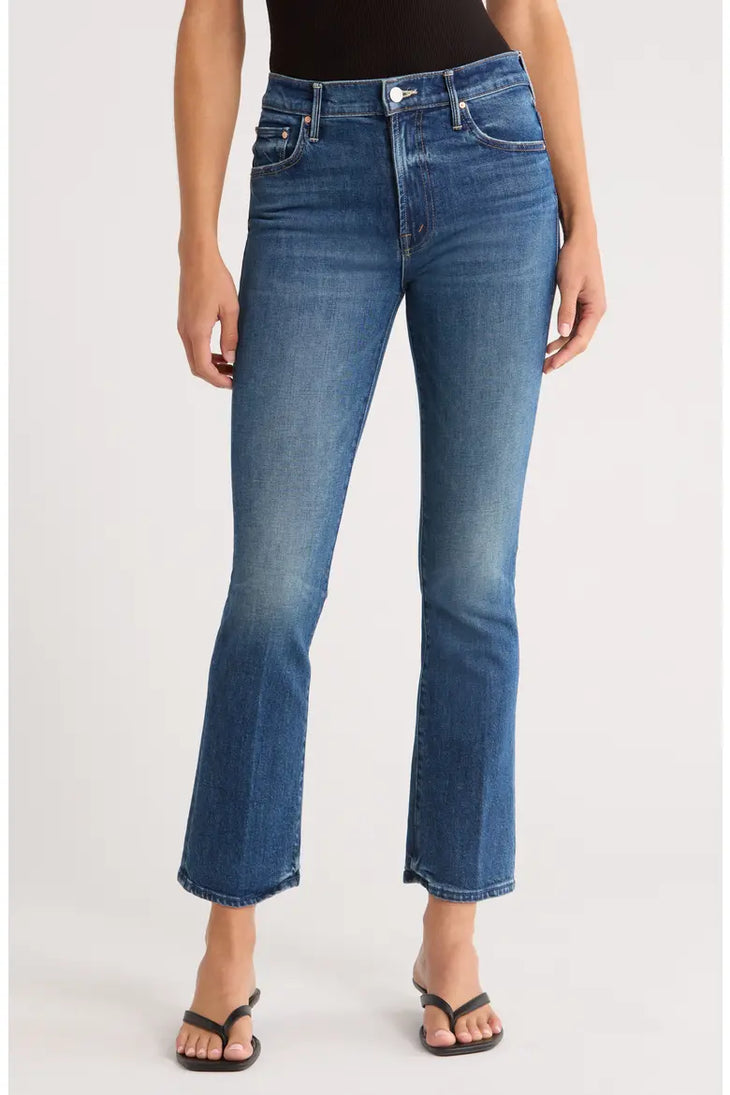 Woman wearing blue denim ankle bootcut jeans with black sandals — Mother | Endless UAE