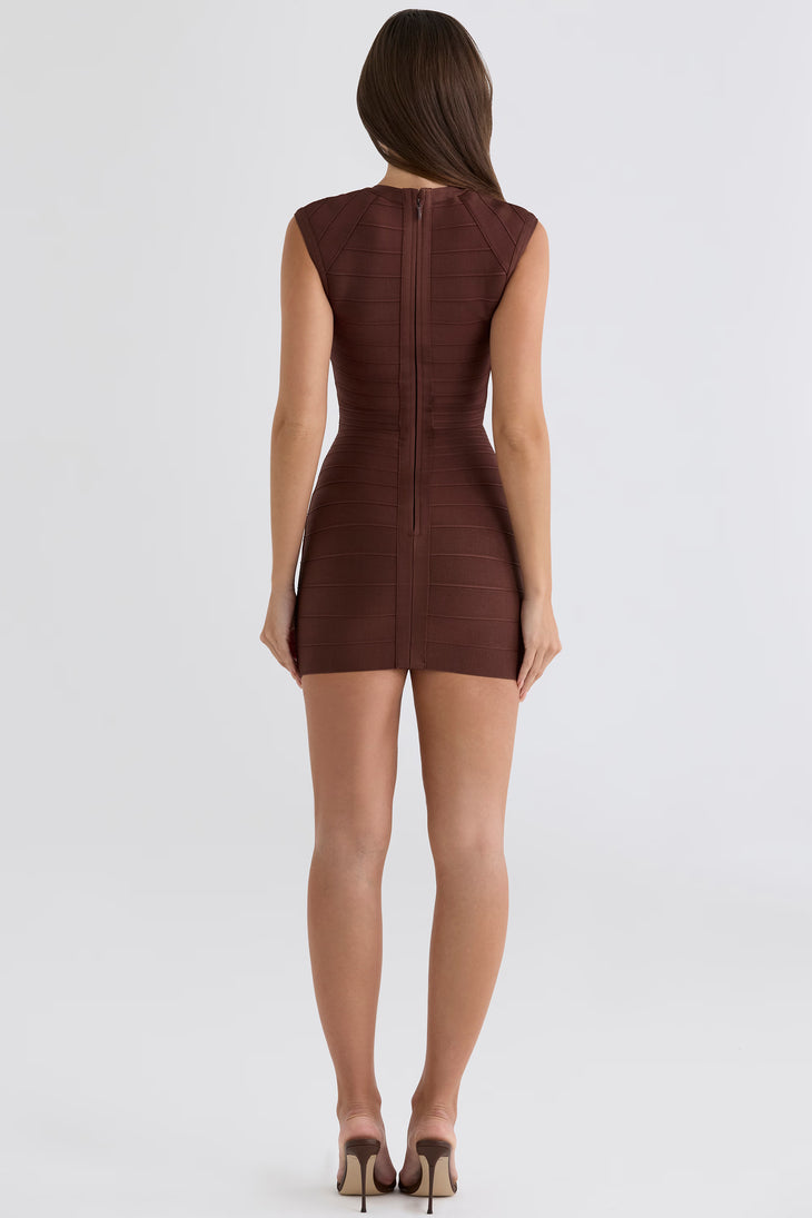 Woman wearing a bronze sleeveless bandage mini dress with cap sleeves against a white background — House of CB | Endless UAE