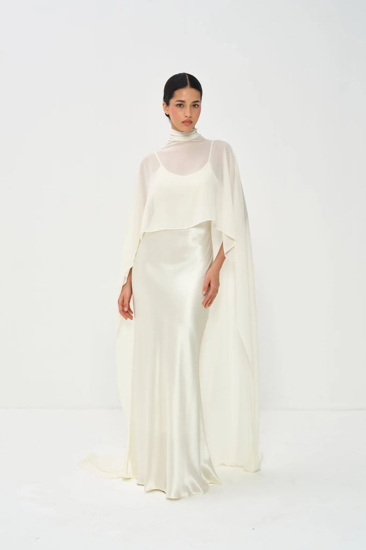 Estelle Cape Maxi Gown in cream with draped cape overlay and turtleneck — Nora The Label | Endless UAE