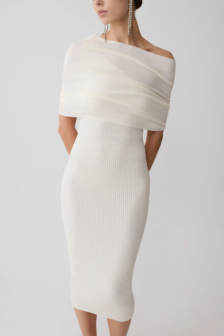 Woman wearing cream cashmere blend knit midi dress with draped off-shoulder overlay and white pointed heels — Meshki | Endless UAE