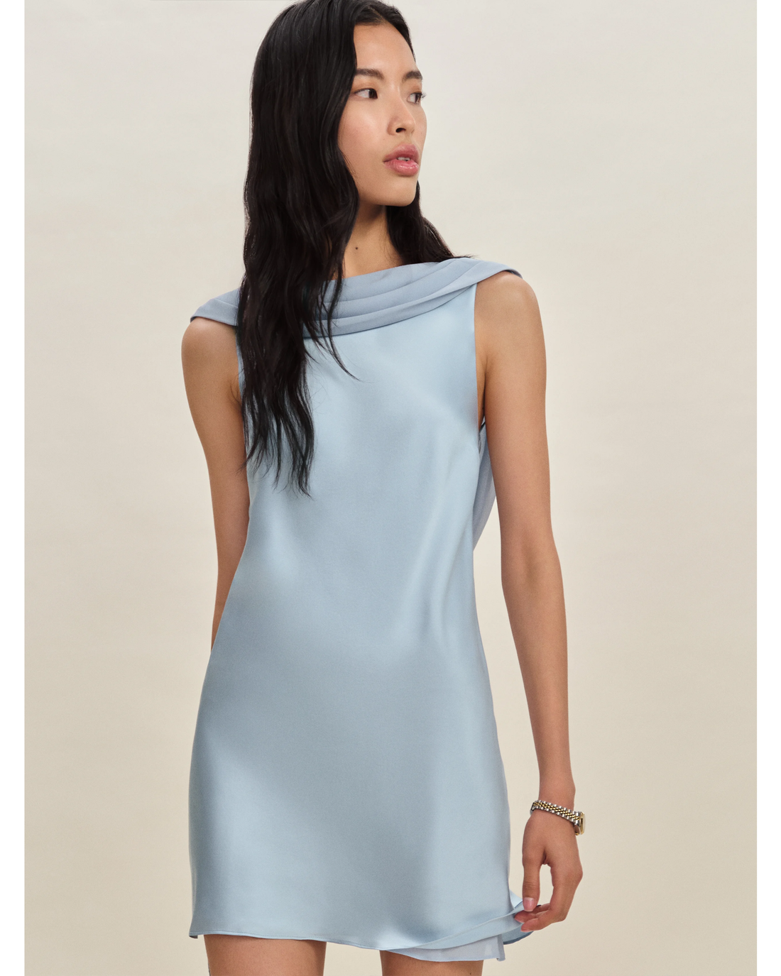 Woman wearing a light blue sleeveless silk dress with draped neckline — Reformation | Endless UAE