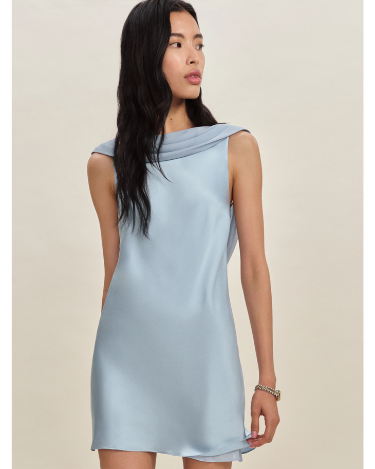Woman wearing a light blue sleeveless silk dress with draped neckline — Reformation | Endless UAE