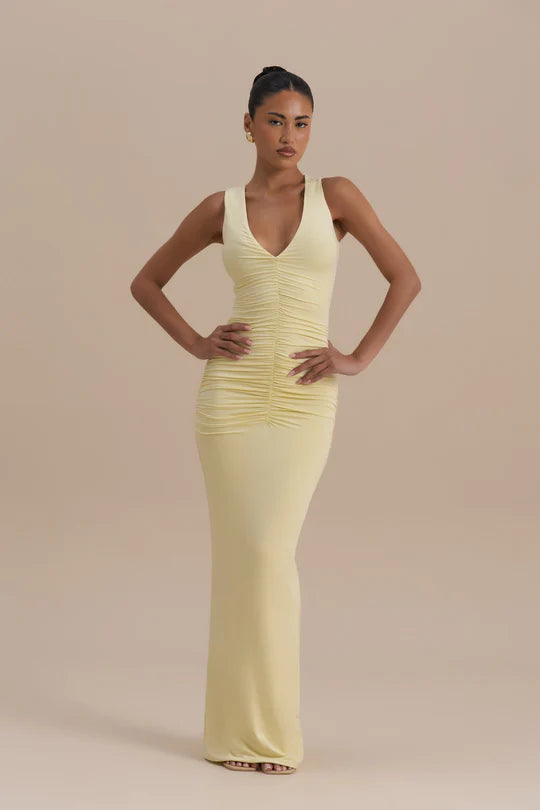 Woman wearing a pale yellow sleeveless maxi dress with ruched detailing — Wanderdoll | Endless UAE