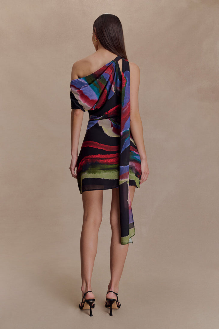 Woman wearing Daisie Chiffon Mini Dress in black with colorful abstract print drape — Meshki | Endless UAE