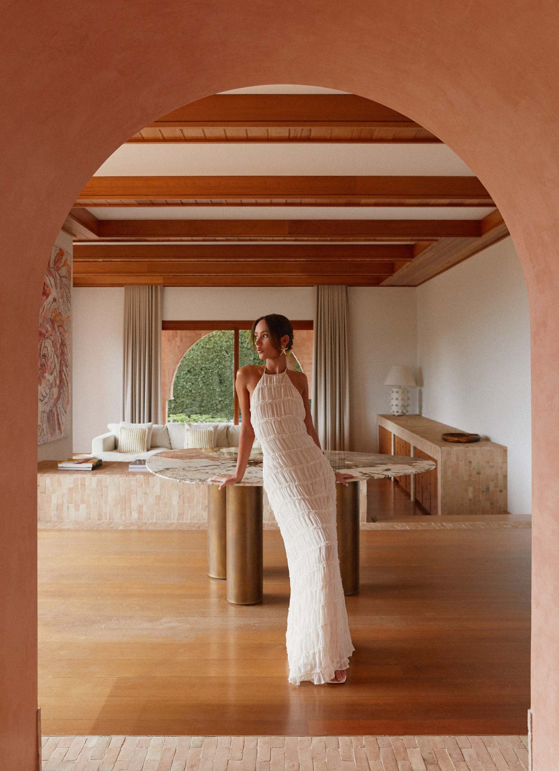 Woman wearing white pleated halter maxi dress in modern interior space — Peppermayo | Endless UAE