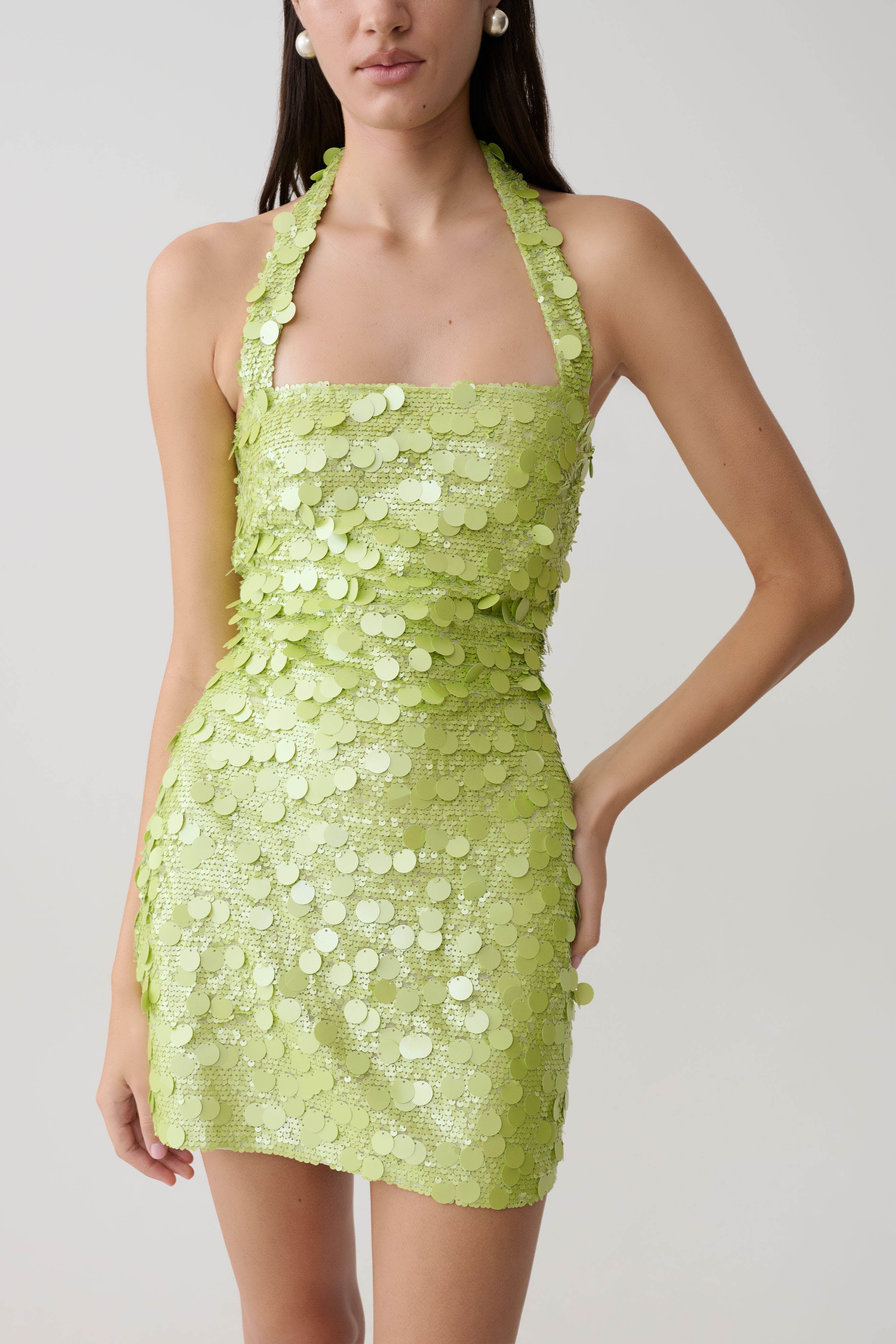 Woman wearing lime green sequin halter mini dress with scalloped neckline — Meshki | Endless UAE