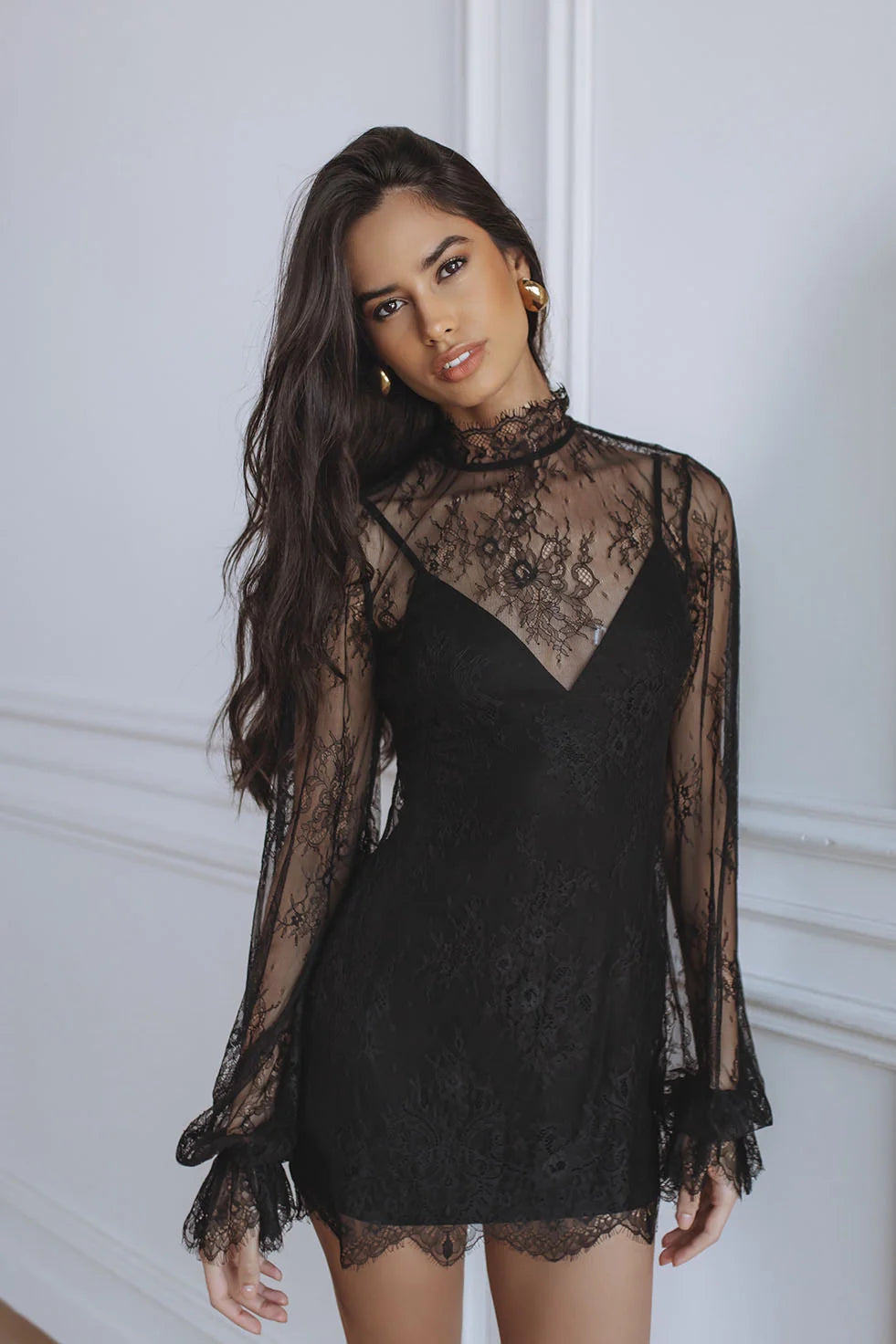 Woman wearing black lace mini dress with sheer long sleeves — Chic Le Frique | Endless UAE