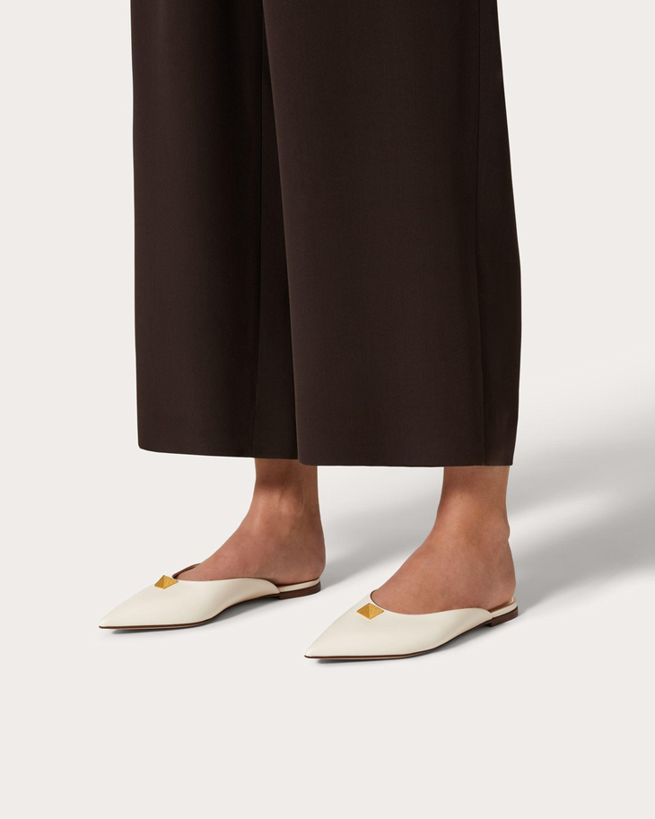Cream leather Roman Stud flat mules with gold pyramid studs and VD logo — Valentino Garavani | Endless UAE