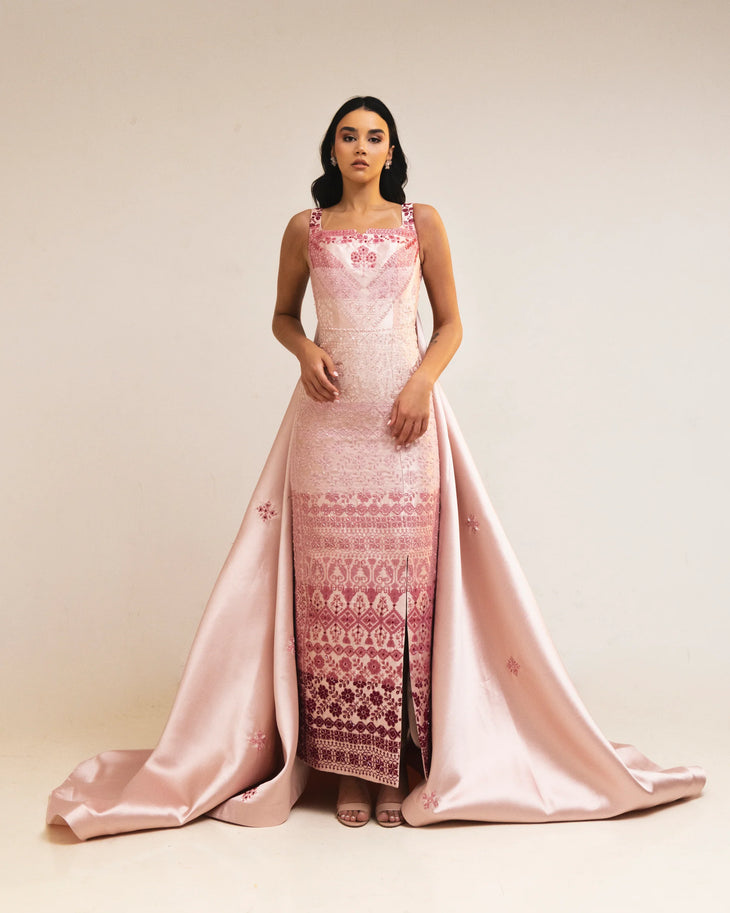 Woman wearing pink embroidered square-neck dress holding thread spools — Reema Dahbour | Endless UAE