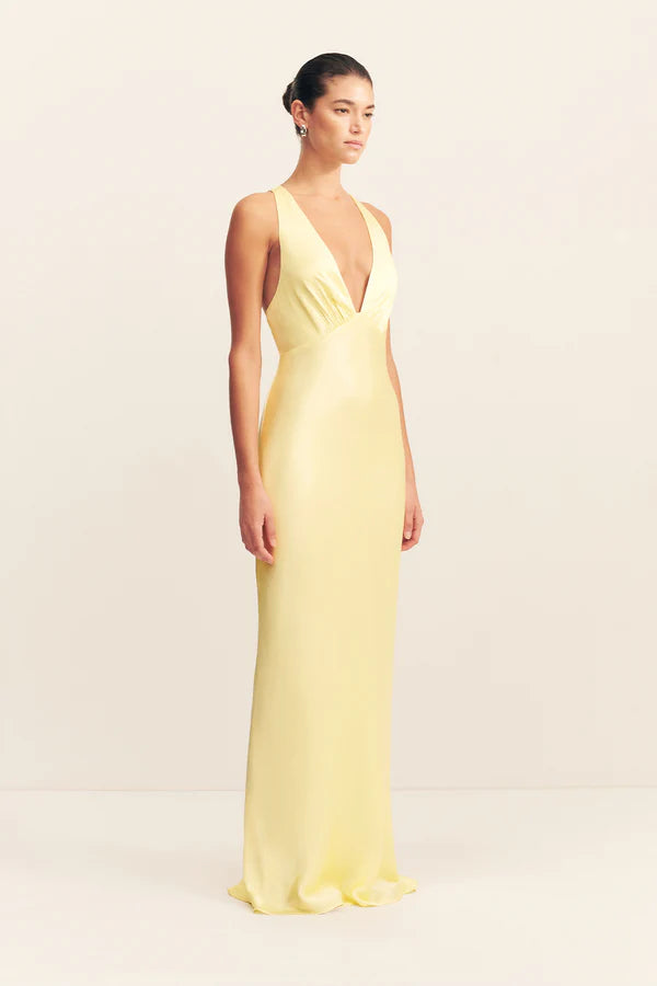 Woman wearing yellow sleeveless plunged neckline maxi dress with cross back detail — Shona Joy | Endless UAE