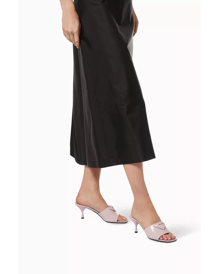 Light pink mule heels with triangle logo detail worn with black midi skirt — Prada | Endless UAE