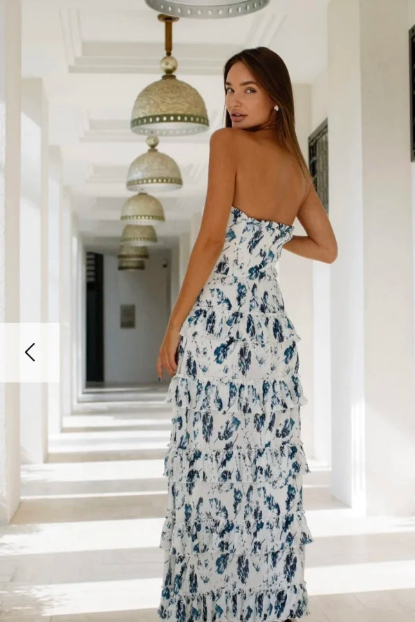 Woman wearing white and navy floral strapless maxi dress in hallway — Anne Louise Boutique | Endless UAE