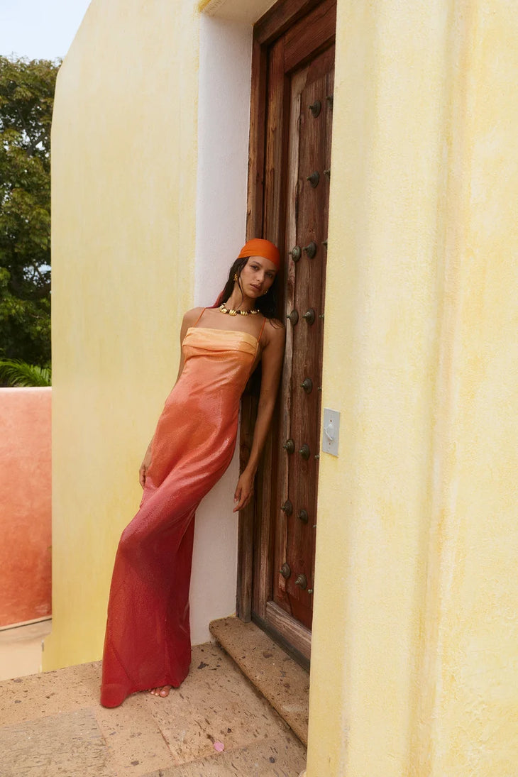 Woman wearing red ombre sequin strapless maxi dress against yellow wall — Bydee | Endless UAE