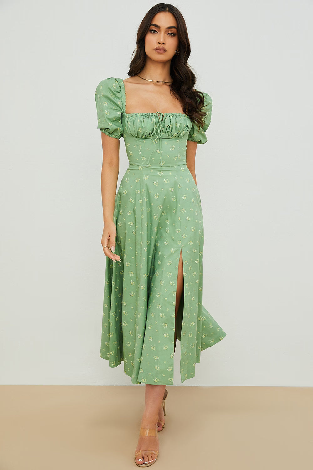 Woman wearing a green floral puff sleeve midi dress with a slit — House of CB | Endless UAE