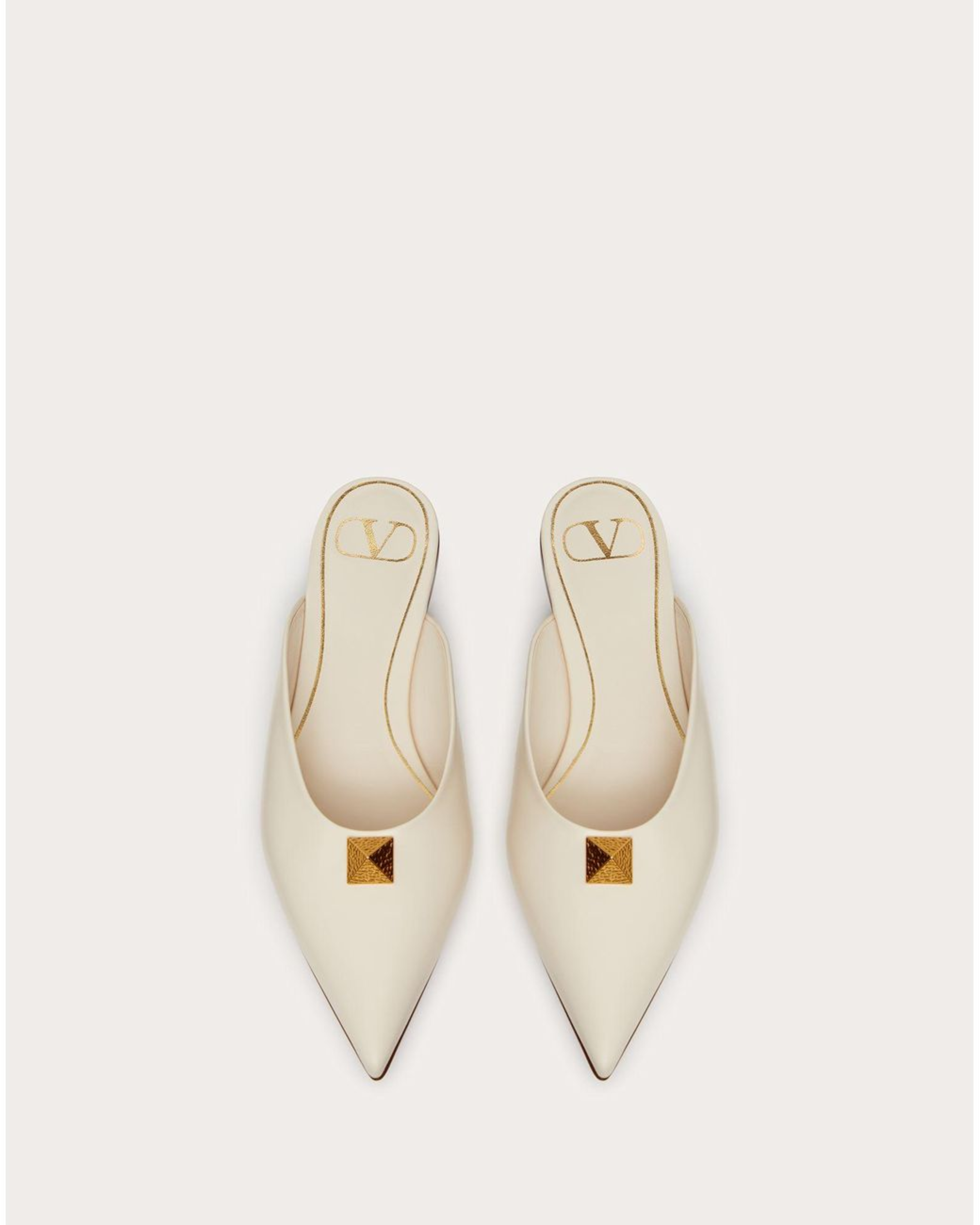 Cream leather Roman Stud flat mules with gold pyramid studs and VD logo — Valentino Garavani | Endless UAE