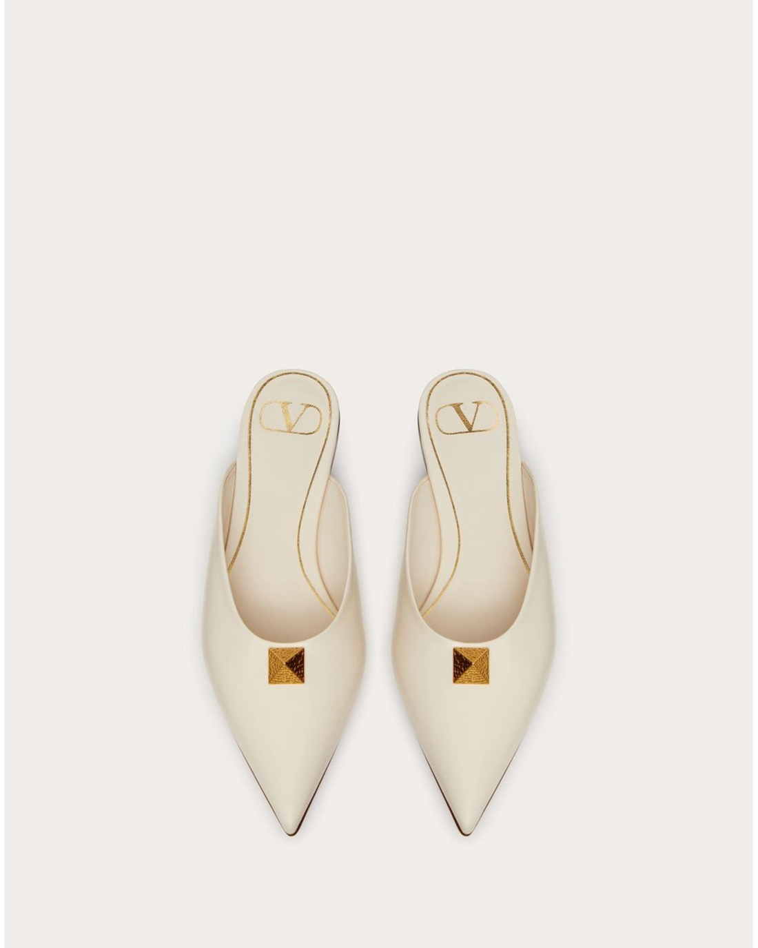 Cream leather Roman Stud flat mules with gold pyramid studs and VD logo — Valentino Garavani | Endless UAE