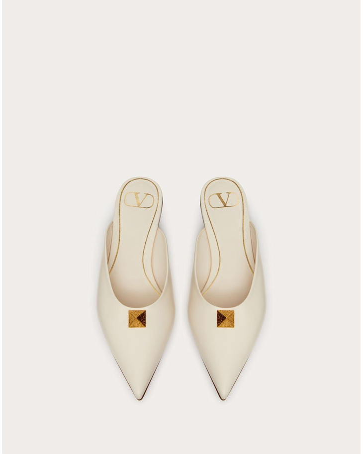 Cream leather Roman Stud flat mules with gold pyramid studs and VD logo — Valentino Garavani | Endless UAE