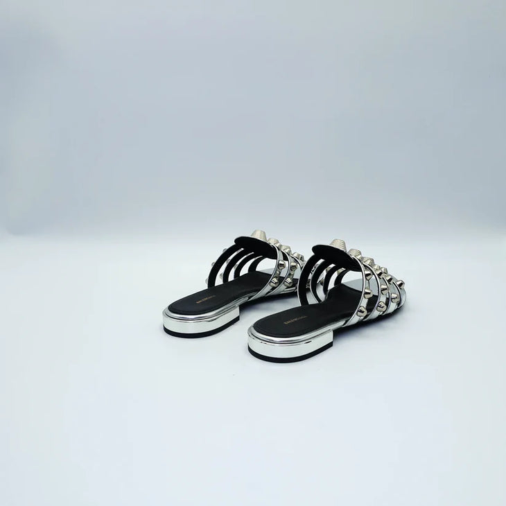Silver studded flat sandals with black straps and metallic accents — Balenciaga | Endless UAE