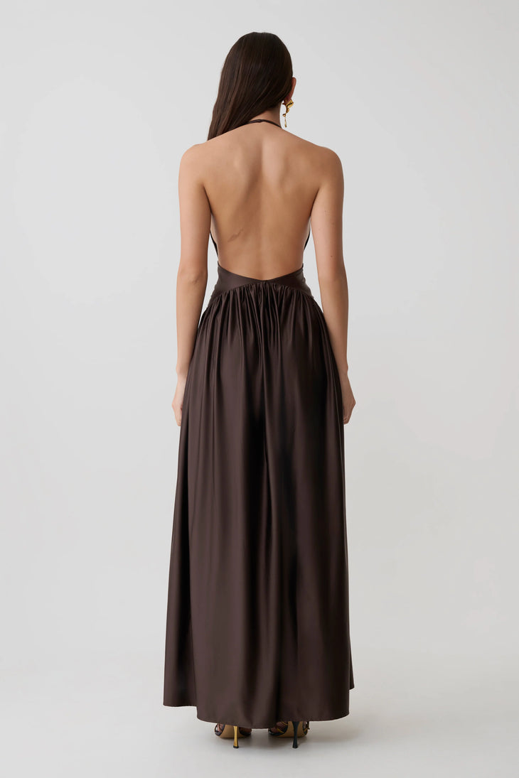 Woman wearing brown halter maxi dress with pleated skirt and gold heeled sandals — Meshki | Endless UAE