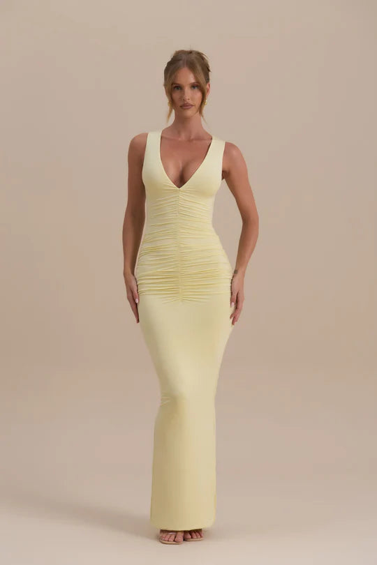 Woman wearing a pale yellow sleeveless maxi dress with ruched detailing — Wanderdoll | Endless UAE