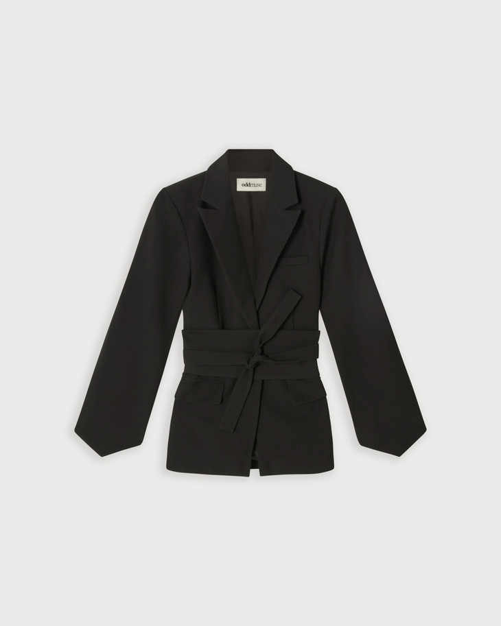 Woman wearing a black belted blazer with long sleeves and matching trousers — Odd Muse | Endless UAE