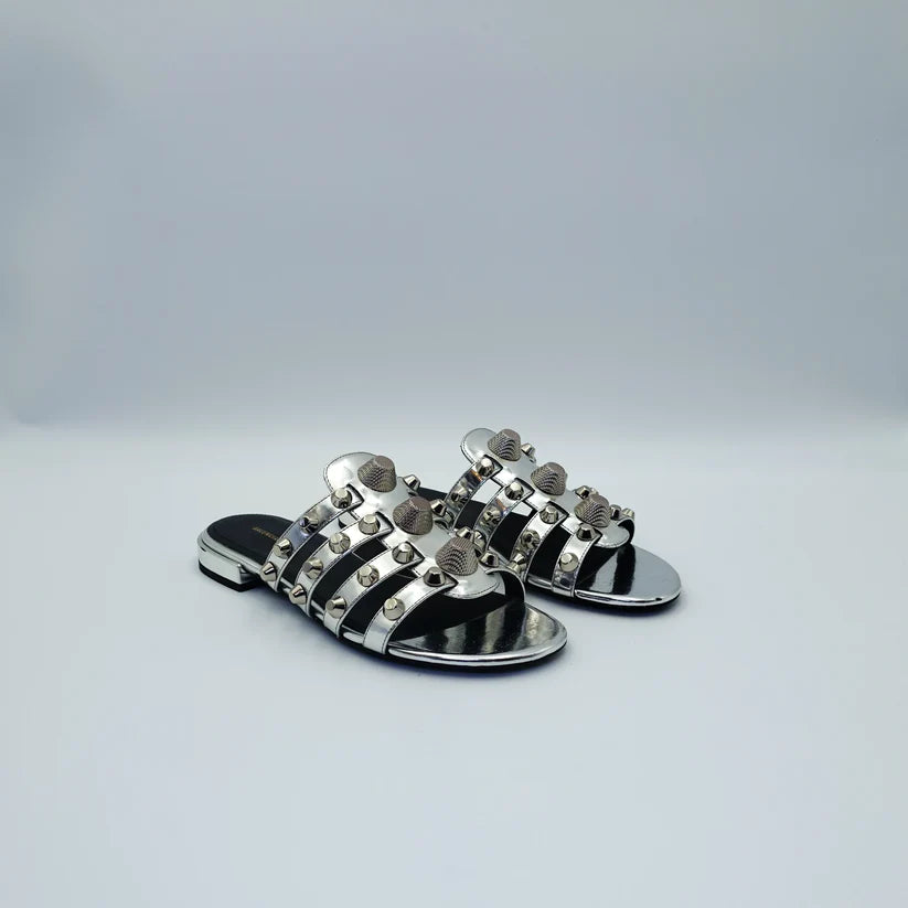 Silver studded flat sandals with black straps and metallic accents — Balenciaga | Endless UAE