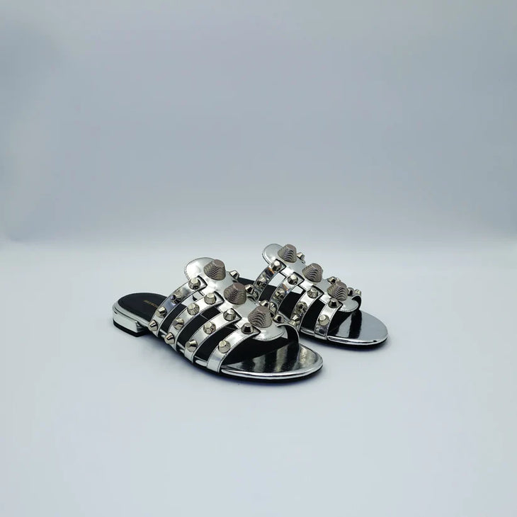Silver studded flat sandals with black straps and metallic accents — Balenciaga | Endless UAE