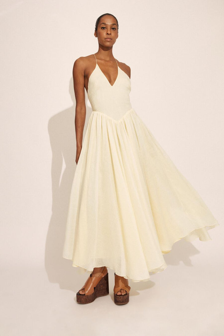 Woman wearing cream halter maxi dress with full skirt and wooden platform sandals — Bardot | Endless UAE