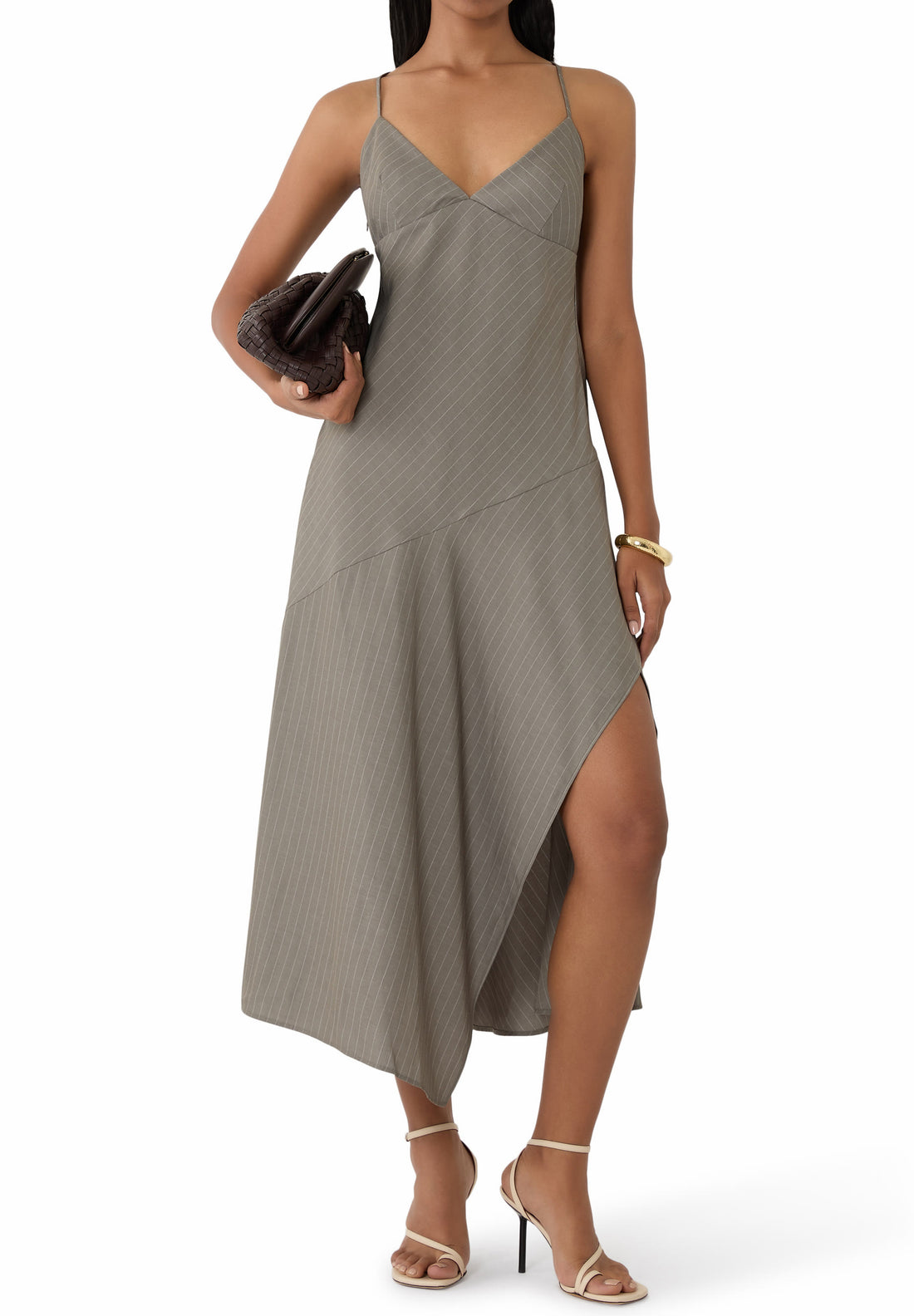 Woman wearing grey pinstriped asymmetric slip dress with thin straps and high slit — St Agni | Endless UAE